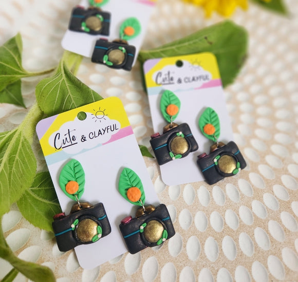 Camera dangles with oranges