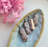 Chocolate Iced Finger Buns with coconut flakes