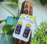Mix cassette tape dangles. Yellow glittery stud tops