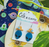 Alien Cowboy dangles. Blue Alien with blue flower