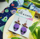 Alien Cowboy dangles. Purple alien with purple flower