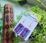 Mix cassette tape dangles. Purple and blue