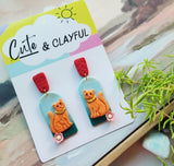 Orange kitties with red tops snd pink flower 🌸