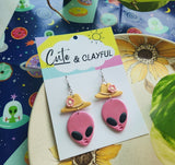 Alien Cowboy dangles. Pink alien with pink flower