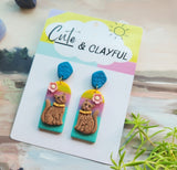 Brown kitties on rainbow background with blue tops snd pink flower