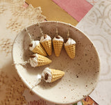 Vanilla soft serve dangles with flakes